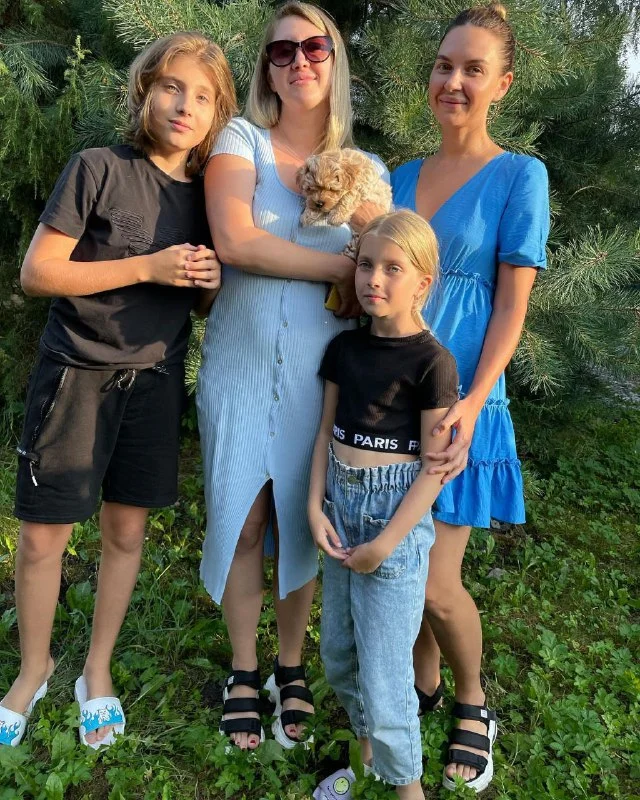 Family picking up a Maltipoo puppy in . .